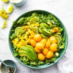 bowl of healthy fruit salad with pieces of mango avocado and cantaloupe