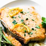 healthy baked salmon filet with maple dijon glaze on white plate