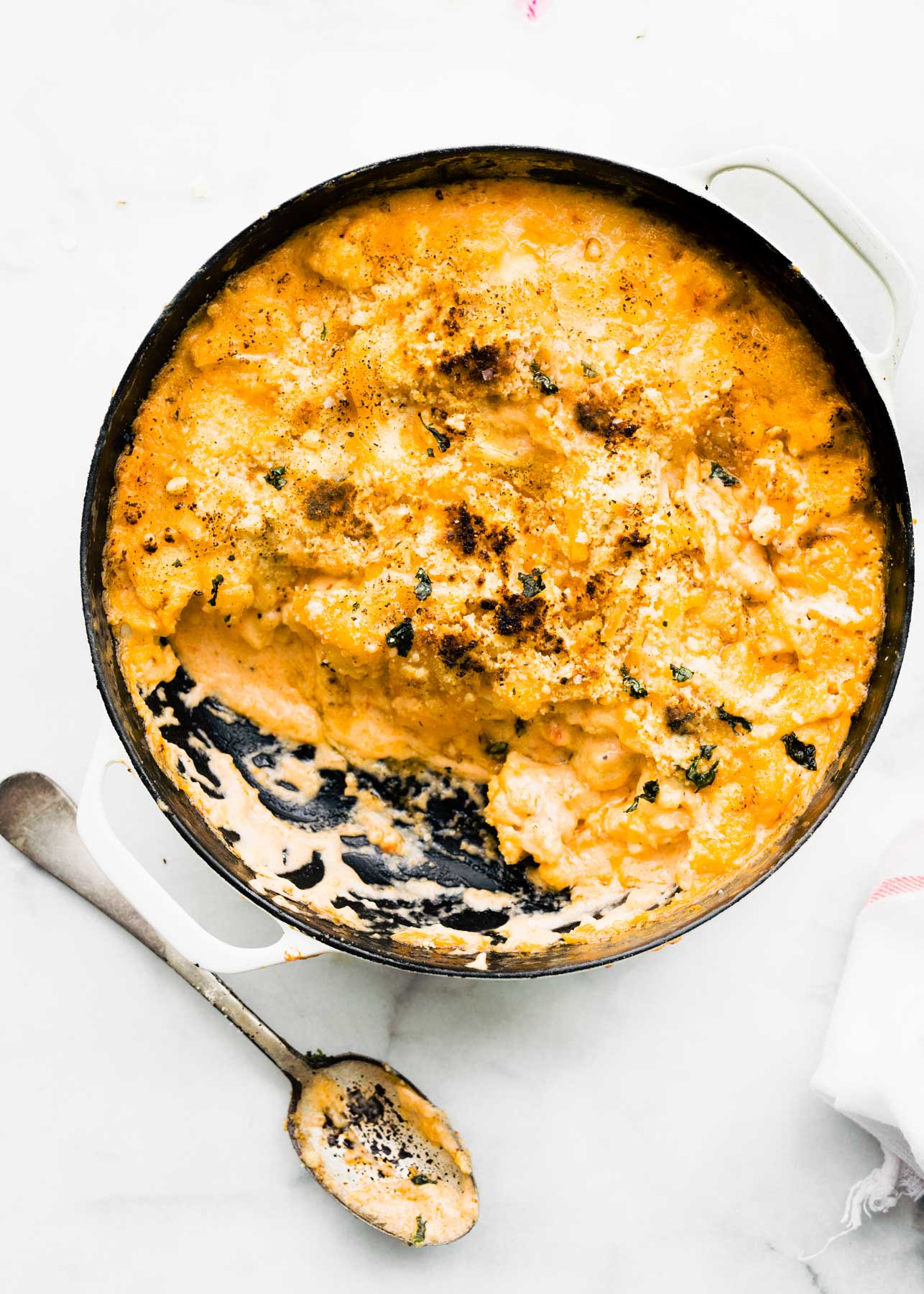 overhead view serving removed from casserole dish of gluten free cheesy pasta casserole