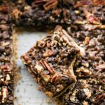 pan of pecan date bar cookies, one with bite removed