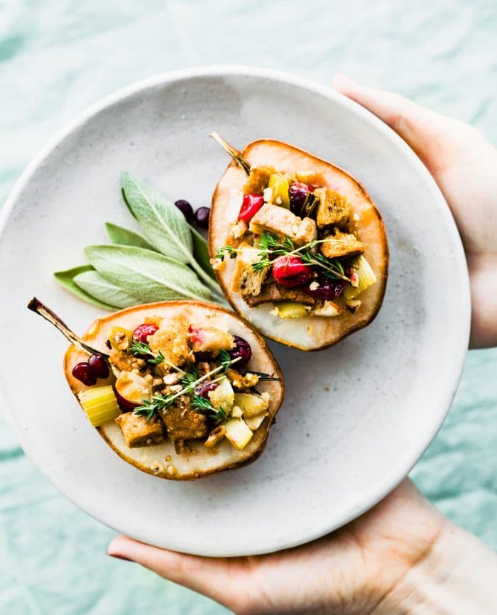 vegan stuffing in baked pears on white plate