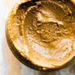 overhead closeup: creamy sunflower butter in a jar