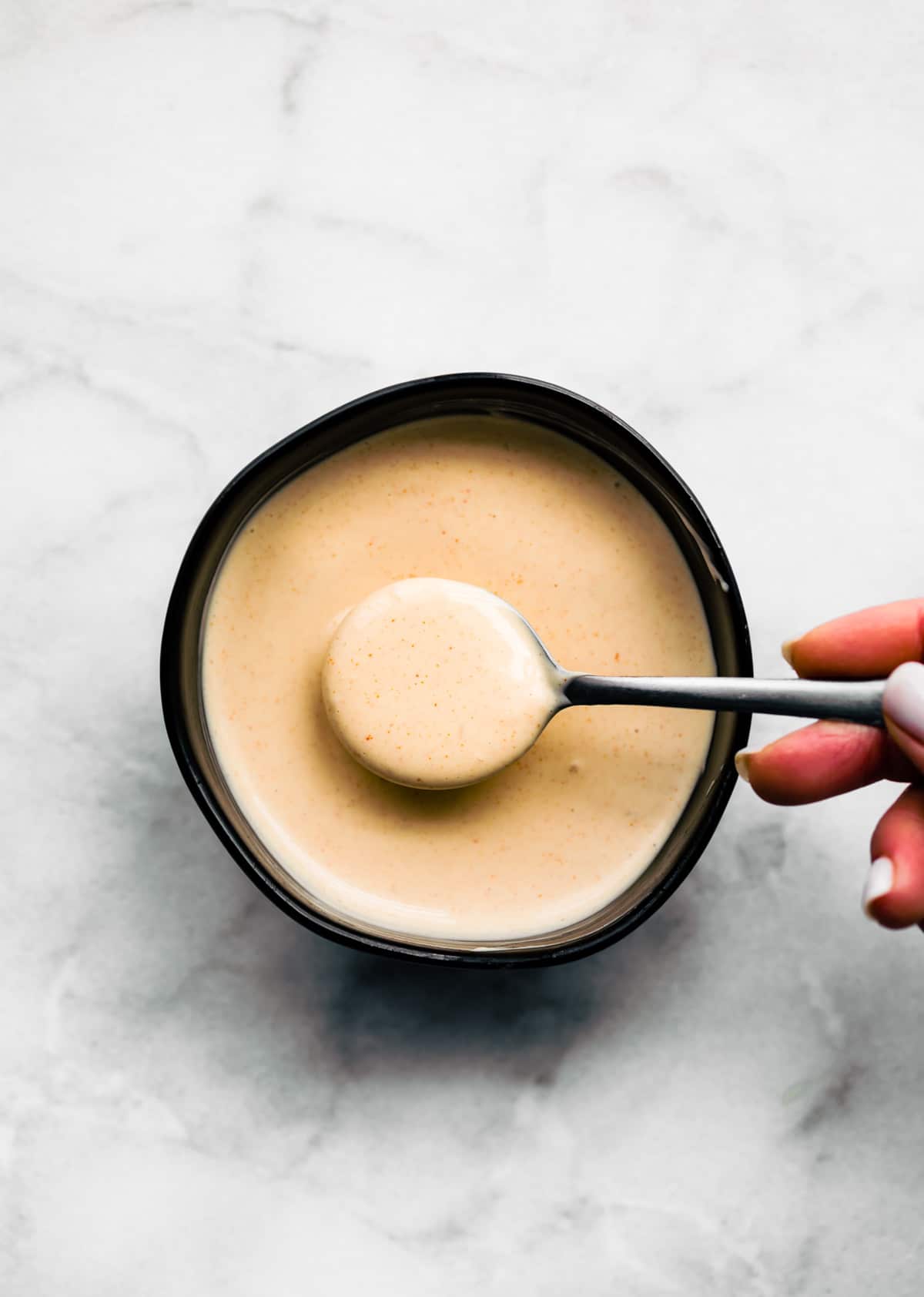 overhead image: Japanese sakura sauce on spoon over bowl of the sauce