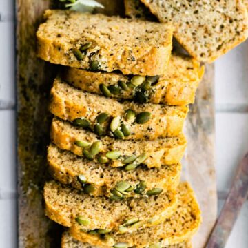 Overhead photo of sliced grain free paleo bread with pumpkin seeds on top.