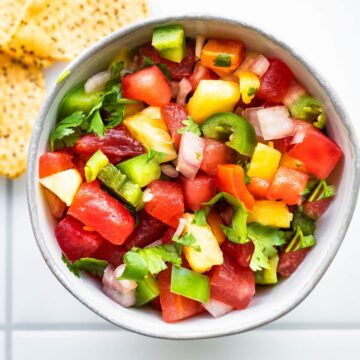 An overhead view of a white bowl of Pineapple Watermelon Salsa