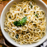 Fettuccine Alfredo in a bowl with fresh herbs