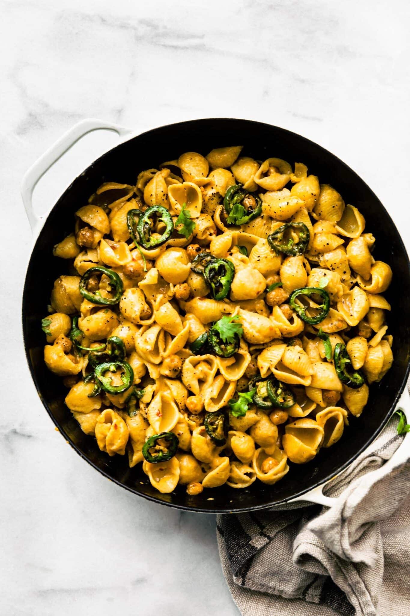 Vegan Jalapeño Chickpea Mac and Cheese in a skillet on a marble counter
