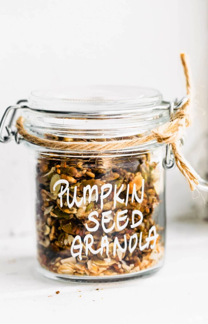 pumpkin seed granola in a jar with twine wrapped around the top