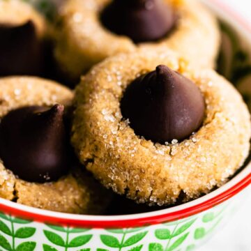 close up image of peanut butter blossom cookies in a bowl