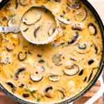 Overhead view of white dutch oven pot filled with creamy Hungarian Mushroom Soup