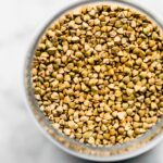 overhead image of buckwheat groats in a glass container