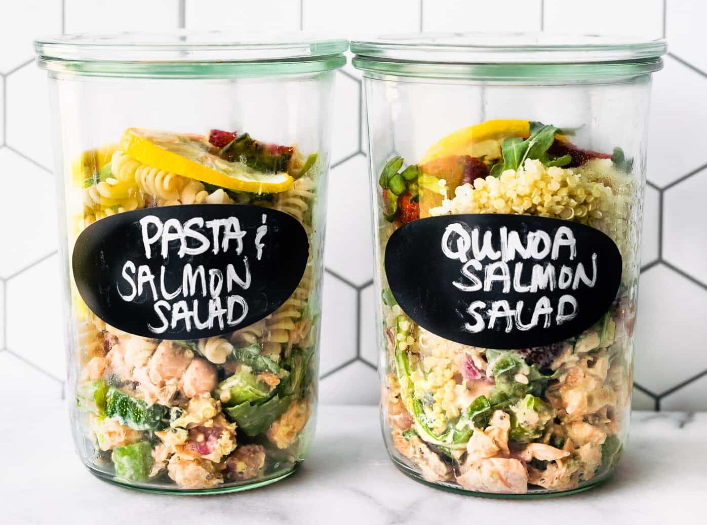 Two Weck jars filled with strawberry salmon salad over pasta in one and quinoa in second jar for meal prep jars.