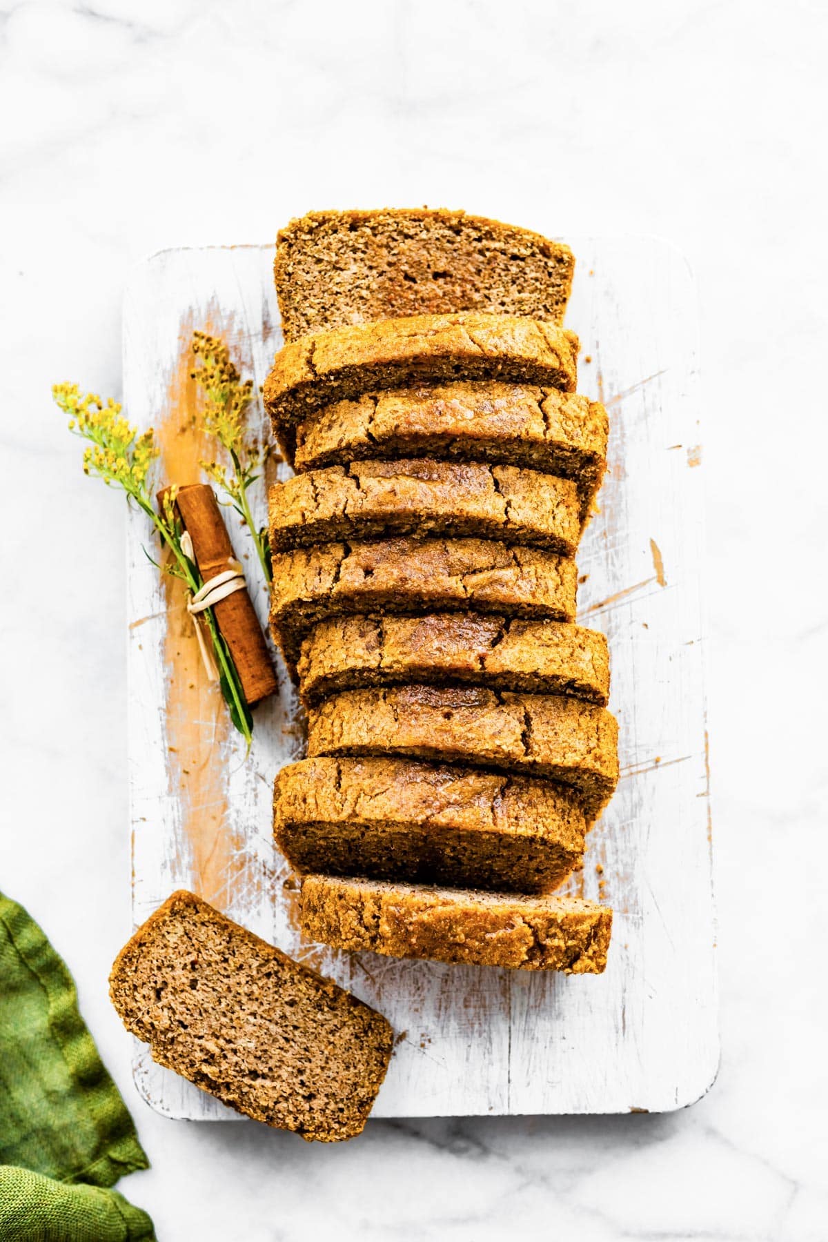a loaf of sliced cinnamon almond flour bread on a cutting board