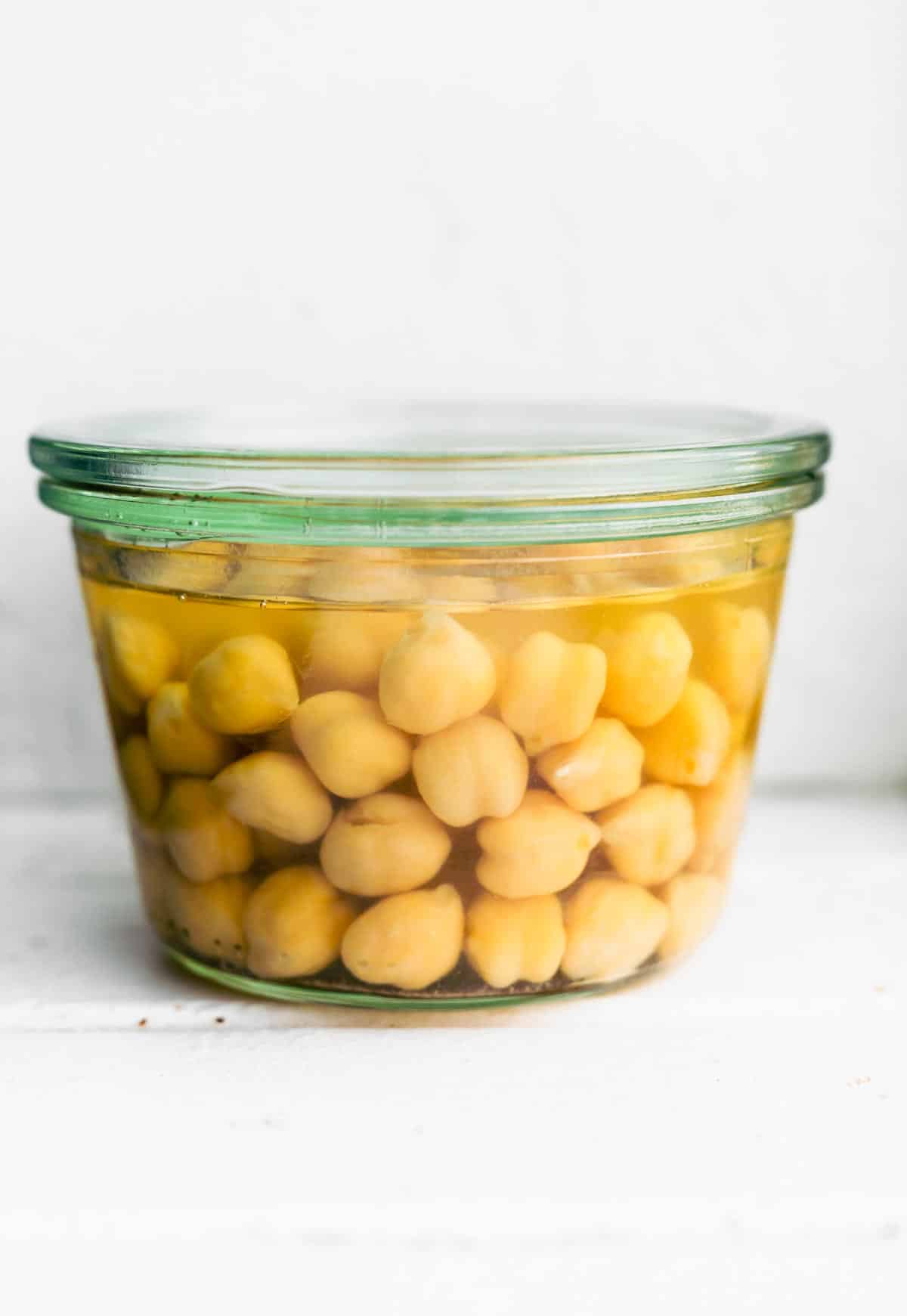 a jar of chickpeas in liquid