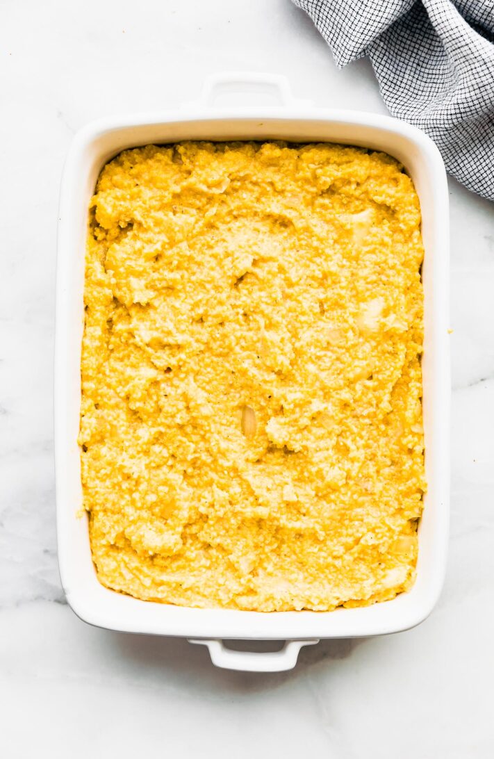 Cooked Polenta Casserole in a white casserole dish