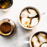 Two mugs of Espresso Con Panna on a counter top