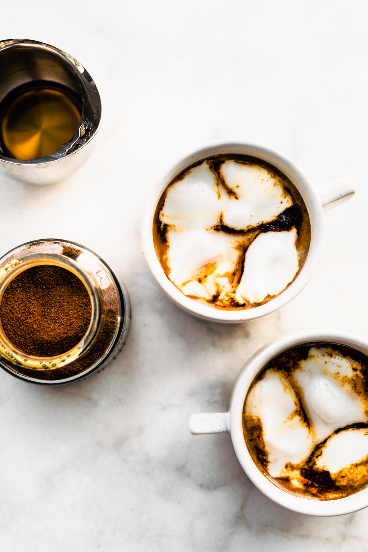 Two mugs of Espresso Con Panna on a counter top