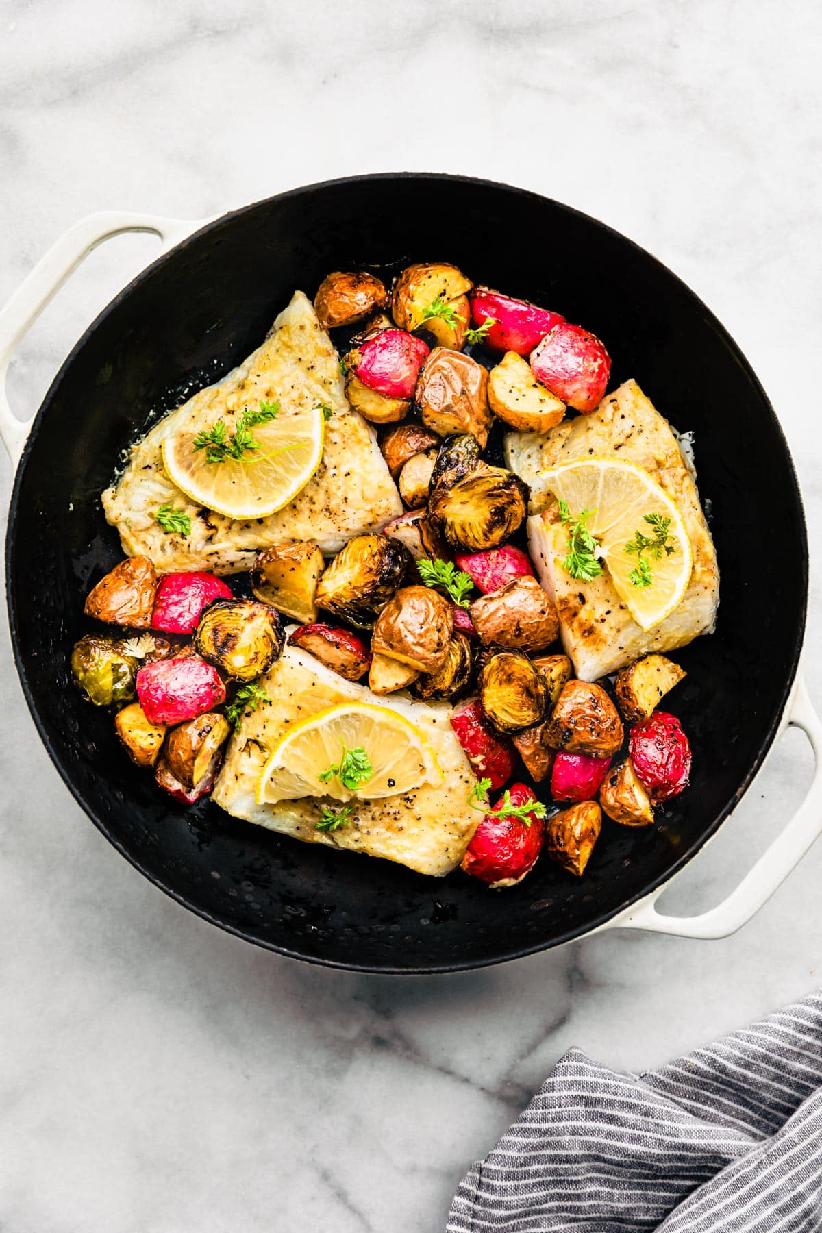 Easy Baked Fish and Vegetables in a pan ready to be served.