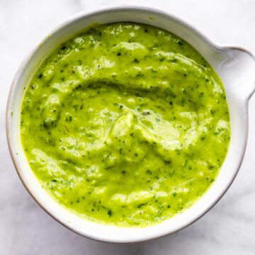 Vegan green goddess dressing in a white bowl.