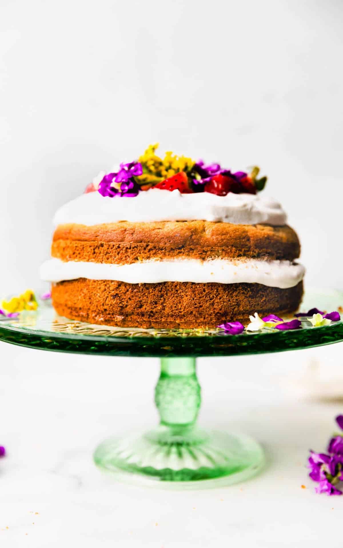 A two tiered dog cake on a cake stand.