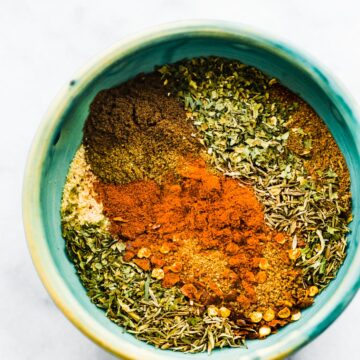 Overhead view of individual spices in a small bowl for jerk seasoning.