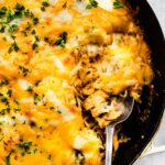 Overhead photo of gluten free spaghetti squash casserole with a spoon in it.