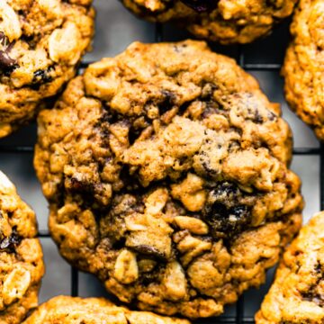 Up close photo of gluten free oatmeal cookies studded with chocolate chips and dried cranberries.