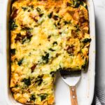 Overhead photo of a pan of gluten free breakfast strata with a slice removed.