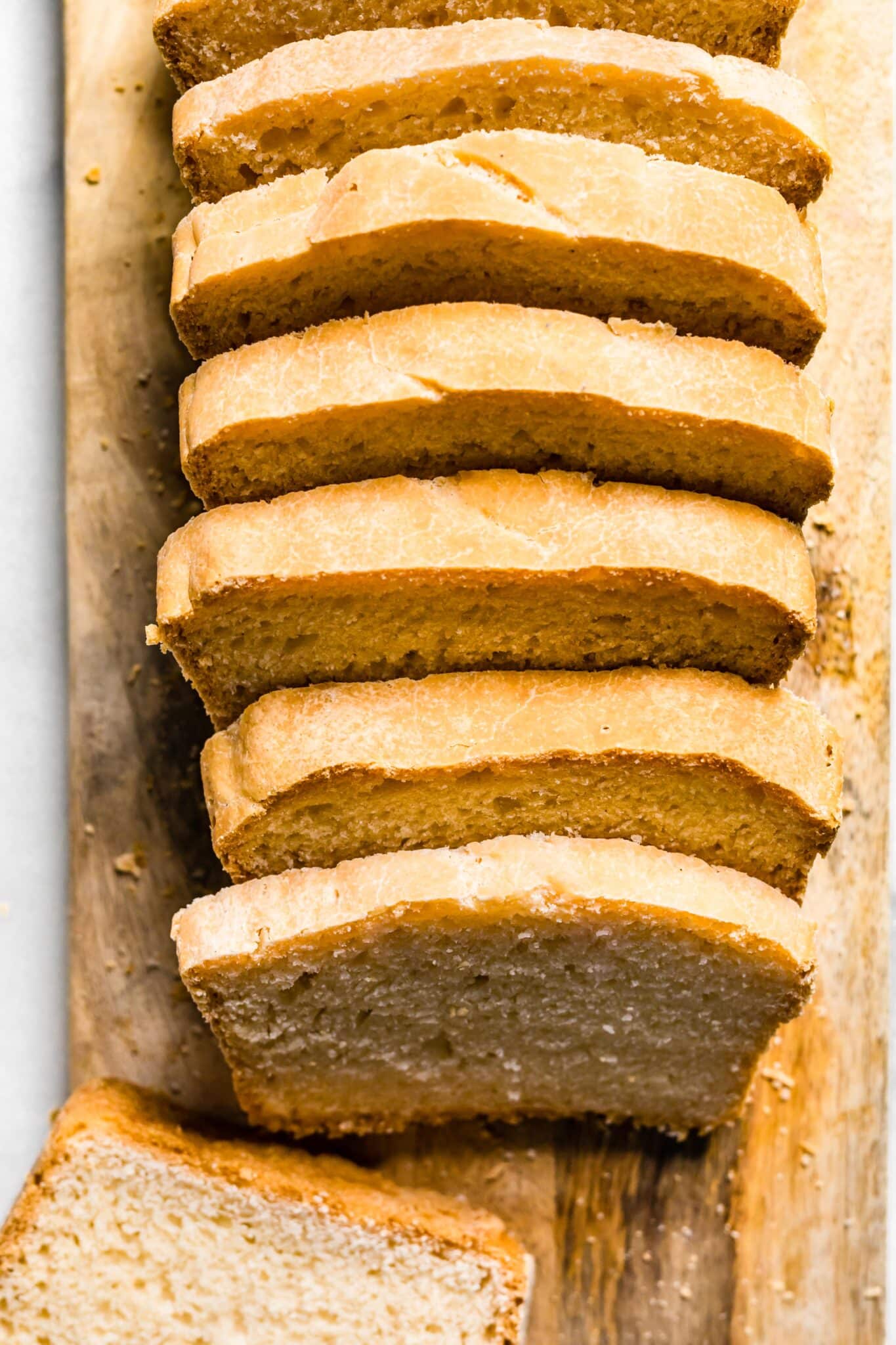 Overhead photo of a loaf of gluten free vegan bread sliced on a cutting board.