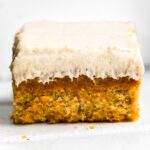 Up close side photo of gluten free frosted banana bread bars.