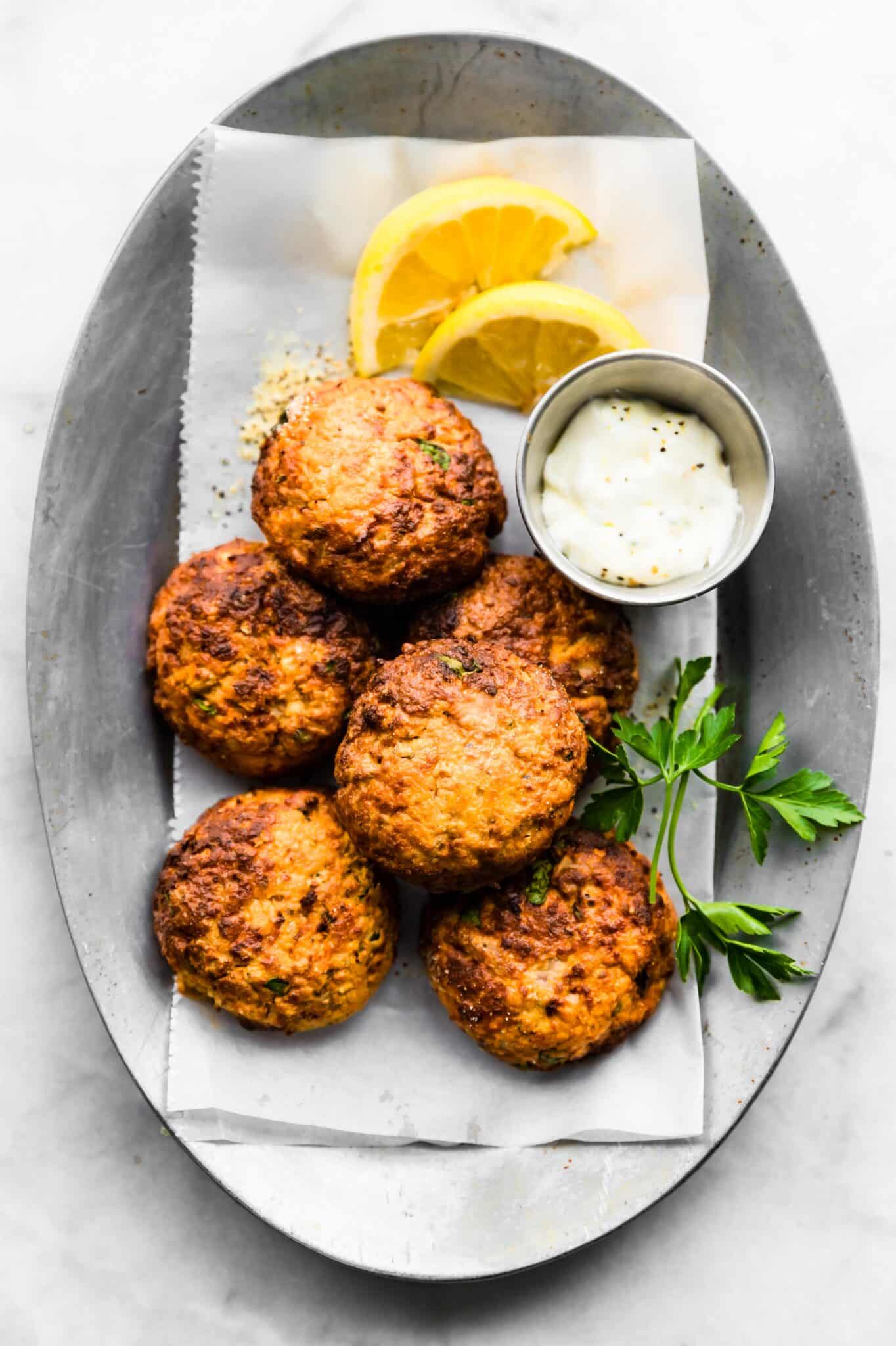 Overhead photo of easy tuna patties stacked on a silver platter.