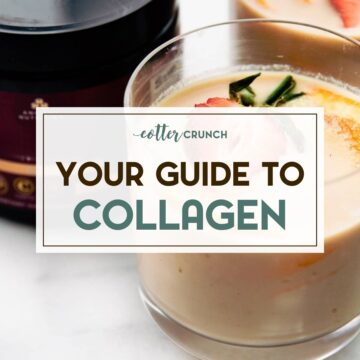 Orange flavored collagen protein drink in small glass with fresh orange and strawberry slices