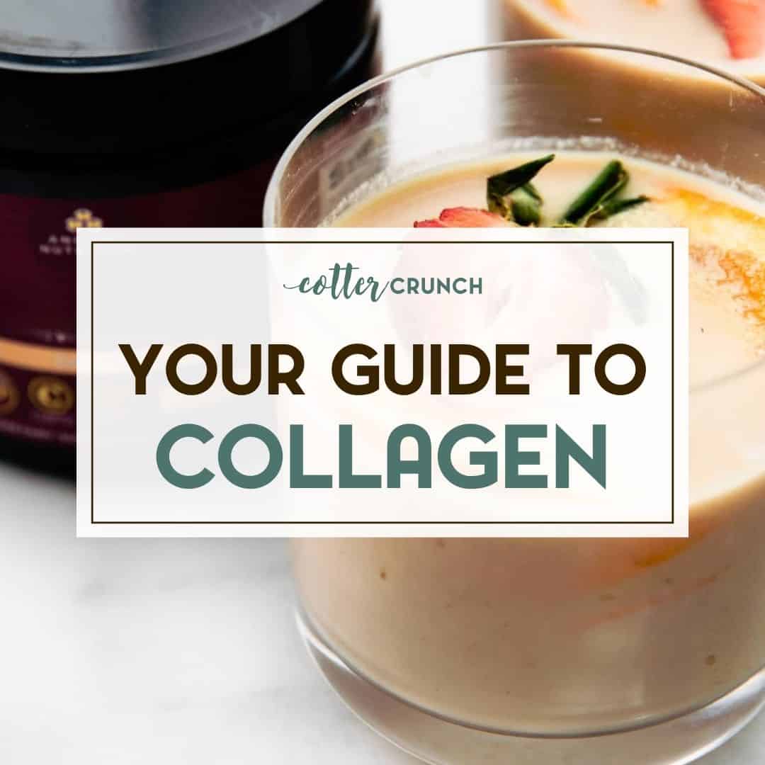 Orange flavored collagen protein drink in small glass with fresh orange and strawberry slices