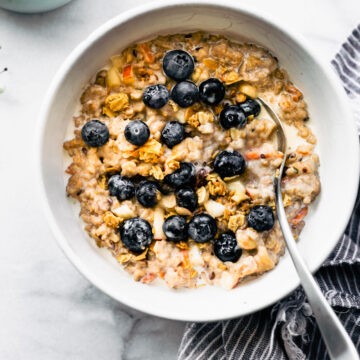 Overhead photo of oatmeal topped with blueberries and cream.