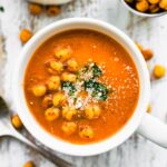 Overhead photo of dairy free carrot soup topped with crispy chickpeas.