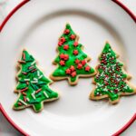 An overhead view of gluten-free cut-out christmas cookies arranged on a plate.
