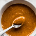 A spoon in a bowl of easy peanut sauce.