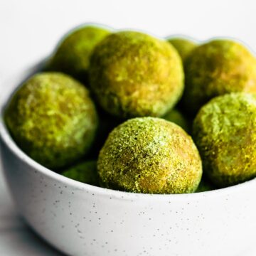 white bowl of green matcha protein bites