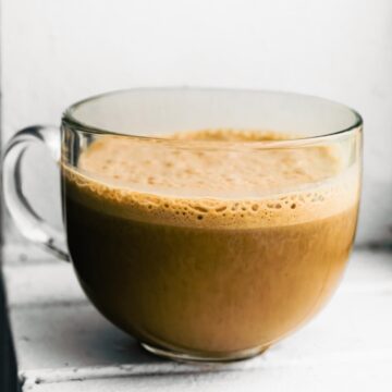 Finished banana latte in a clear glass mug