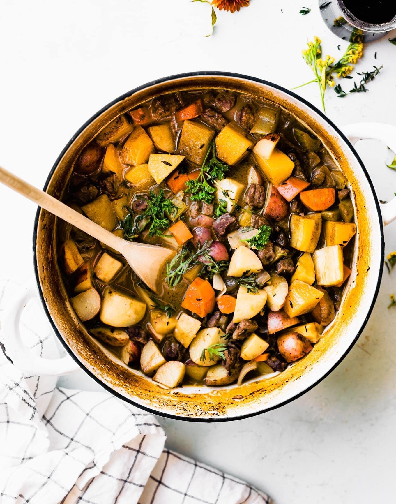An overhead photo of a Dutch oven of gluten-free beef stew with a text overlay for pinterest.