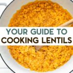 A stock pot with cooked lentils with a text overlay for pinterest.