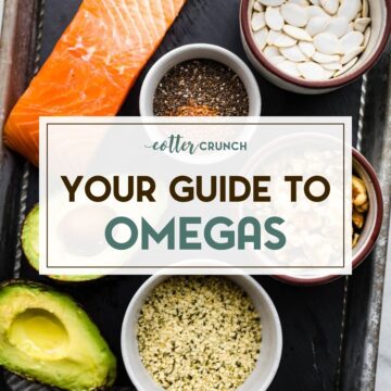 various fat sources including salmon, avocado, and walnuts on a baking sheet