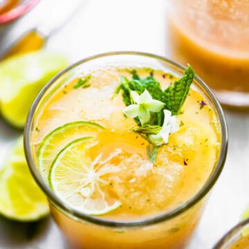 Overhead photo of a detox apple cider vinegar drink recipe topped with mint and lime.
